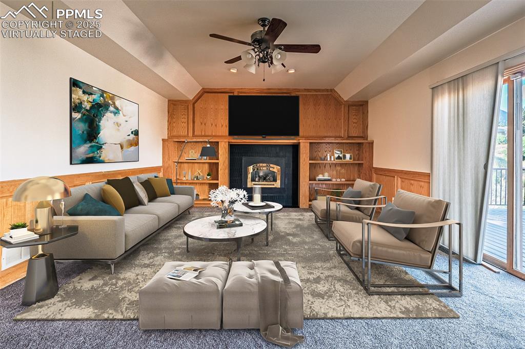 Image 22 of 45: Virtually Staged
Family area featuring wainscoting, fireplace, carpet floo