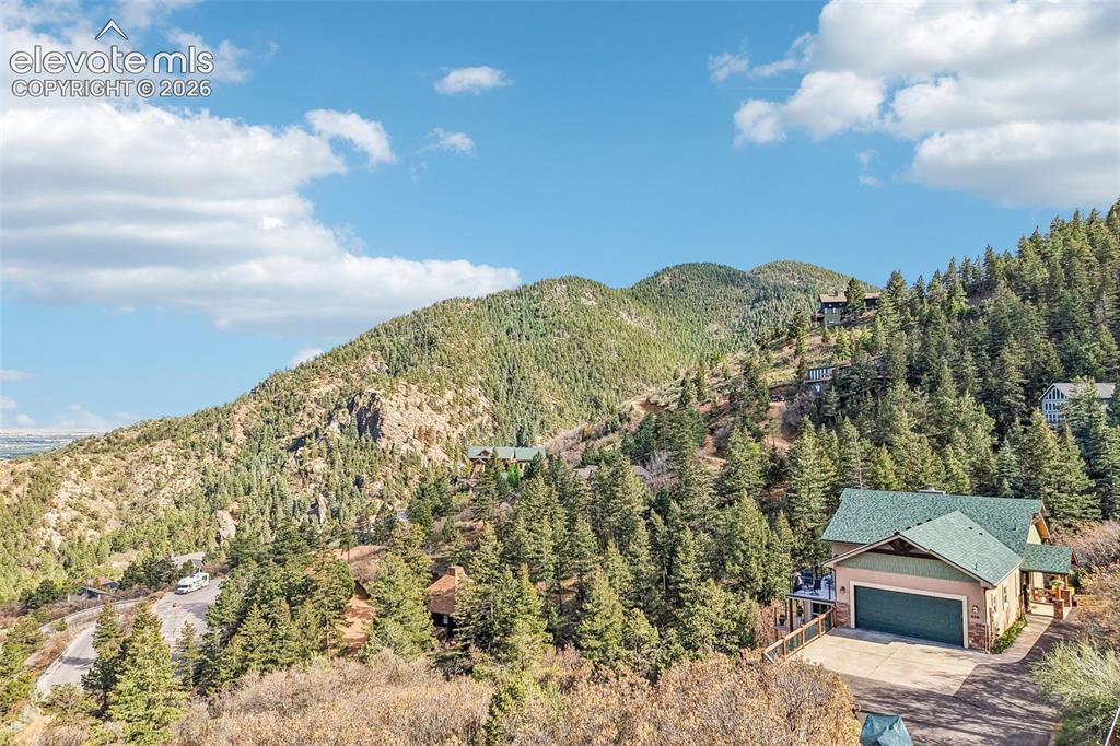 Image 1 of 50: View of this home nestled into the mountain with 360 degree views!