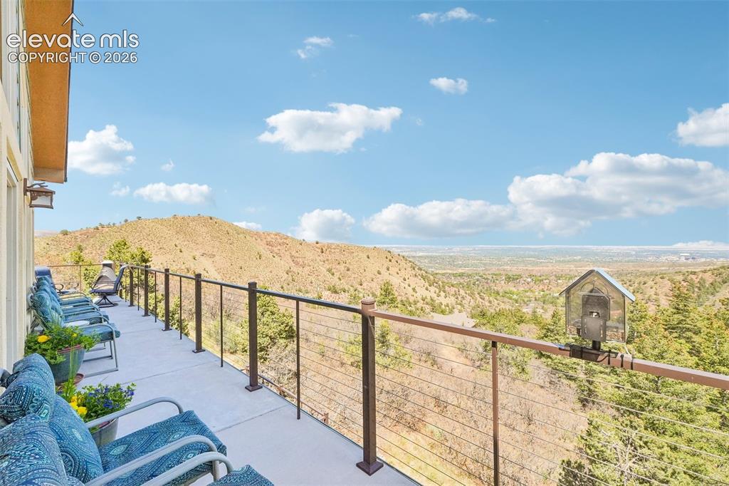 Image 14 of 50: Walk out wrap around concrete deck off the living room. Just look at those