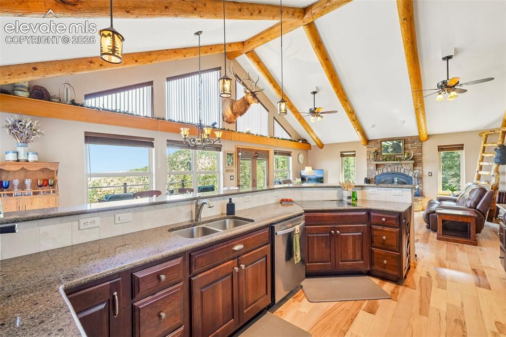 Image 18 of 50: Open concept kitchen with quartz counter tops, matching stainless appliance