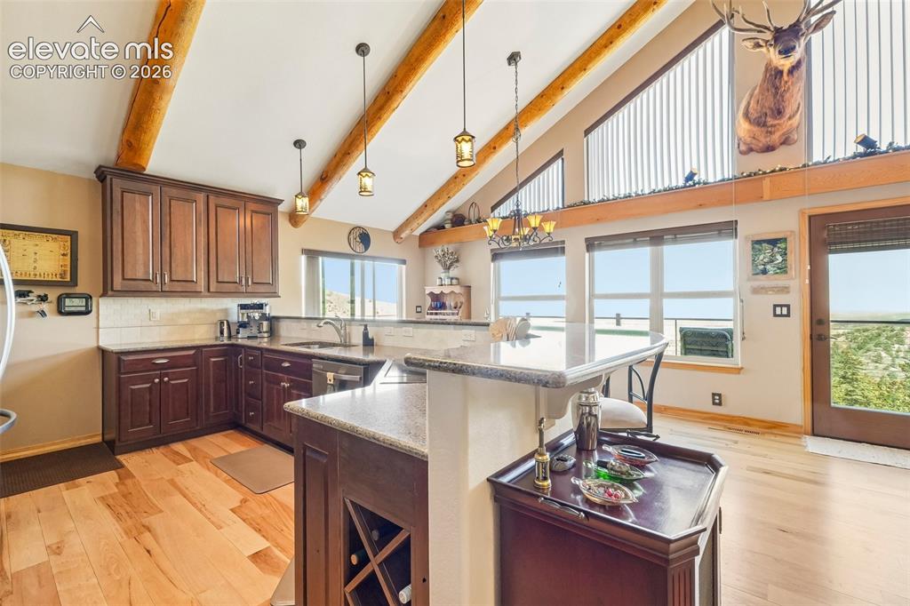 Image 19 of 50: Open concept kitchen with quartz counter tops, matching stainless appliance