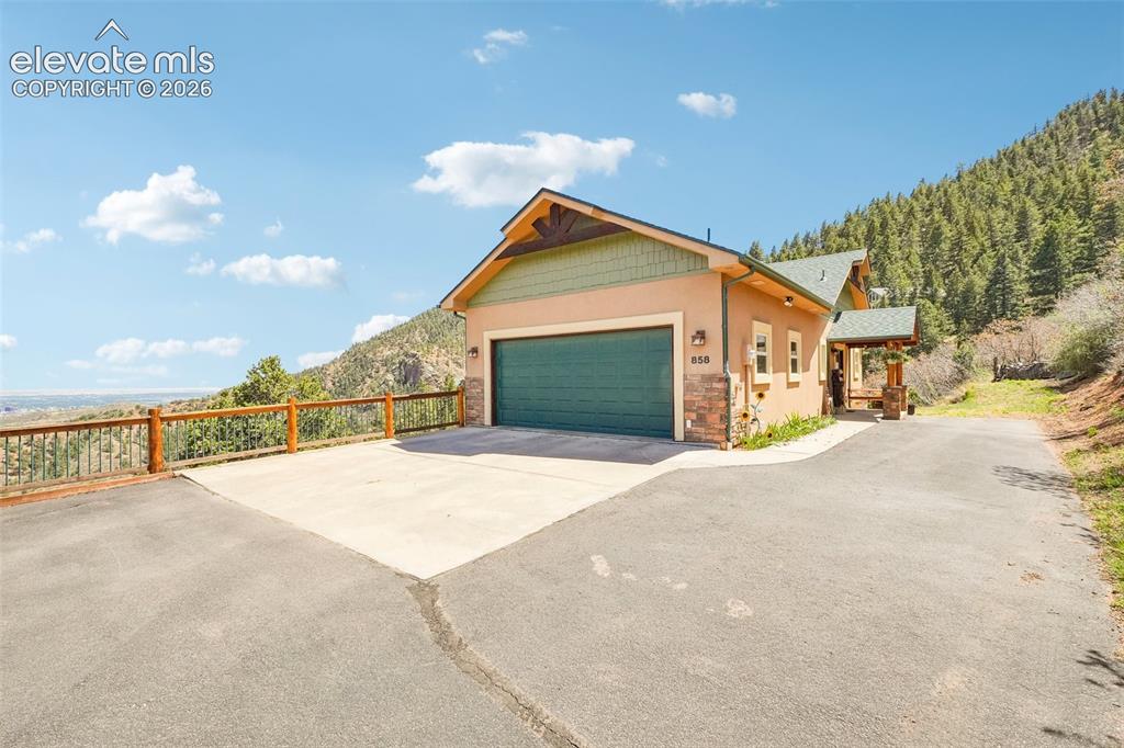 Image 2 of 50: Front of home surrounded by 360 degree views of mountains and Colorado Spri