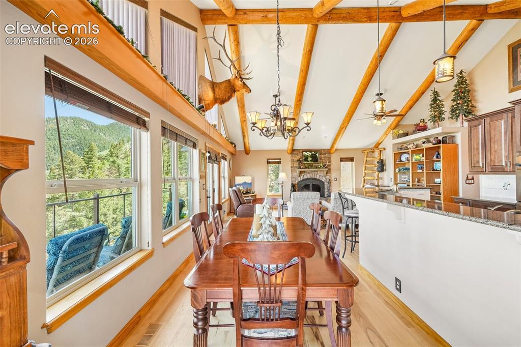 Image 20 of 50: Open concept dining room with walk out to wrap around deck