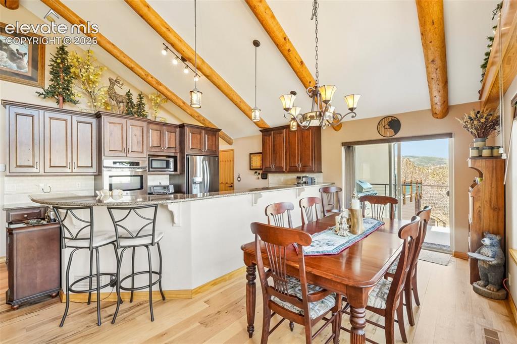 Image 21 of 50: Open concept dining room with walk out to wrap around deck