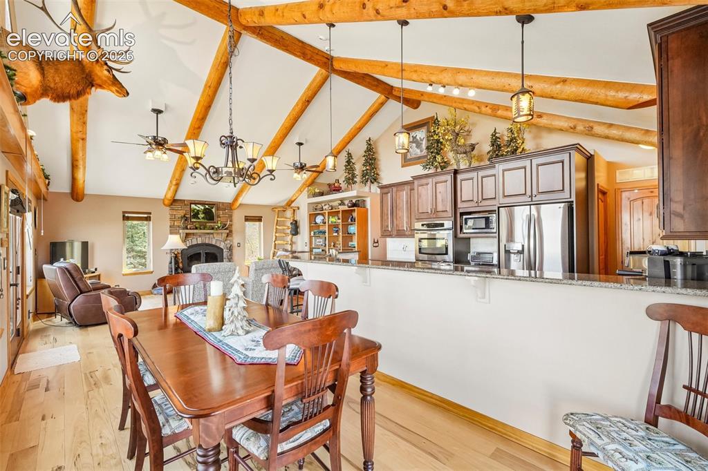 Image 22 of 50: Open concept dining room with walk out to wrap around deck