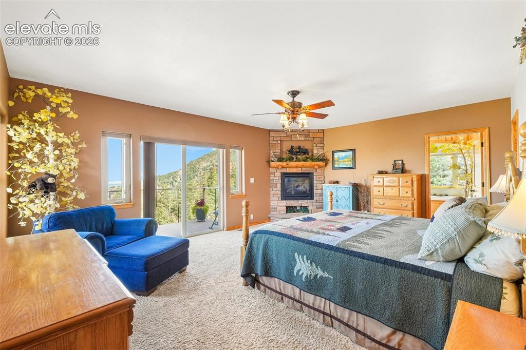 Image 24 of 50: Primary bedroom on lower level with a private walk out deck, a gas fireplac