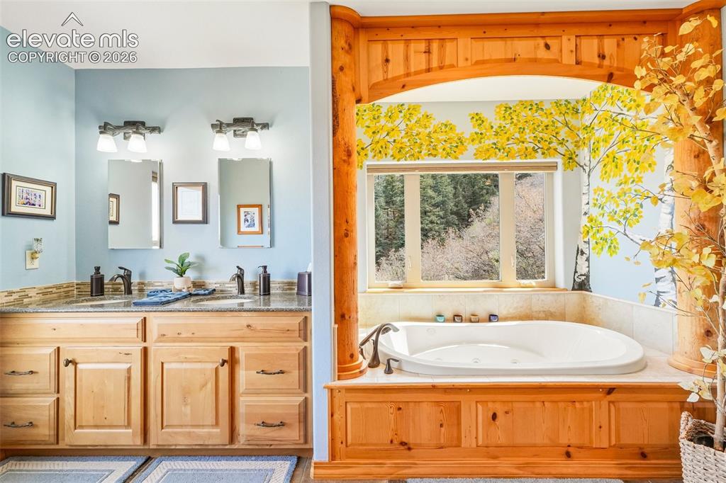 Image 29 of 50: 5 piece en suite bathroom with custom mural, dual sinks, a walk in shower a