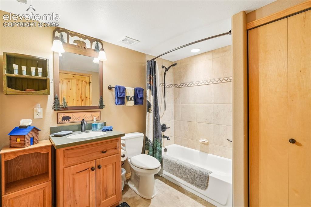 Image 41 of 50: Full bathroom with laundry near bedroom 3 on lower level