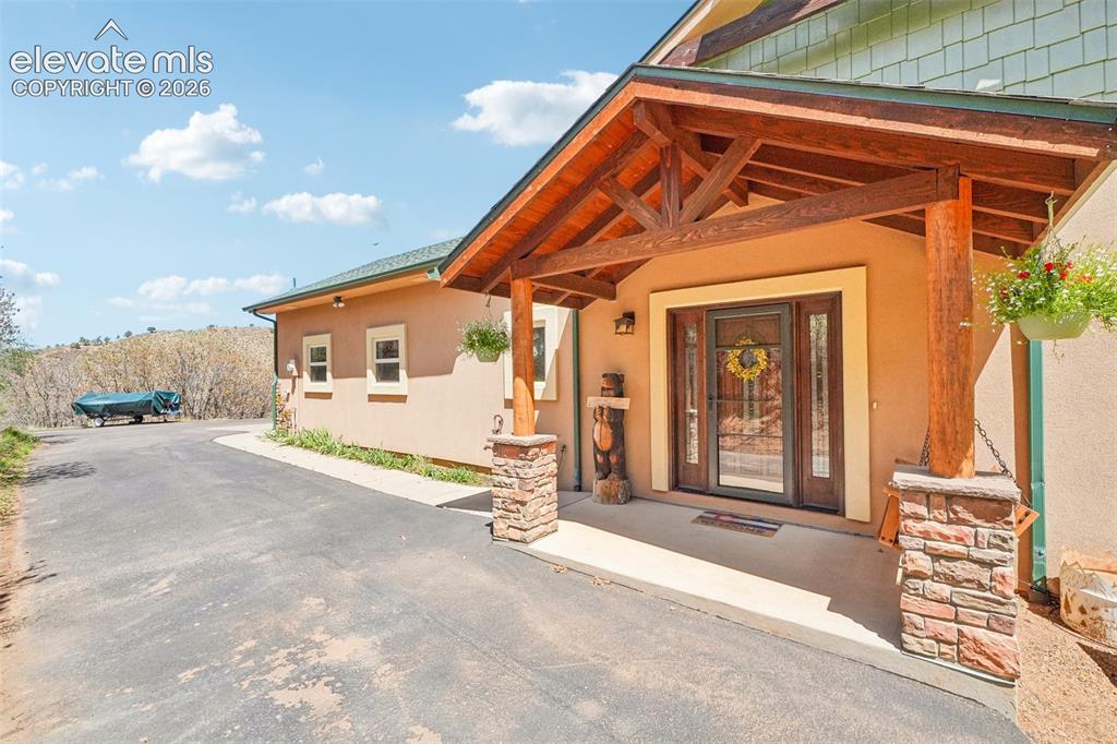 Image 5 of 50: Front entrance/Covered patio