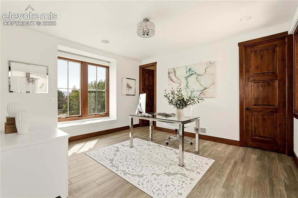 Image 16 of 46: Home office with beautiful mountain views