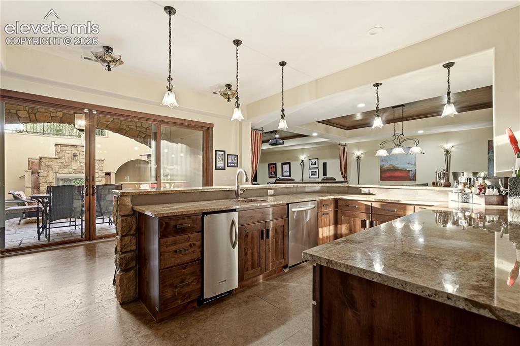 Image 27 of 46: Basement wet bar with courtyard for entertaining