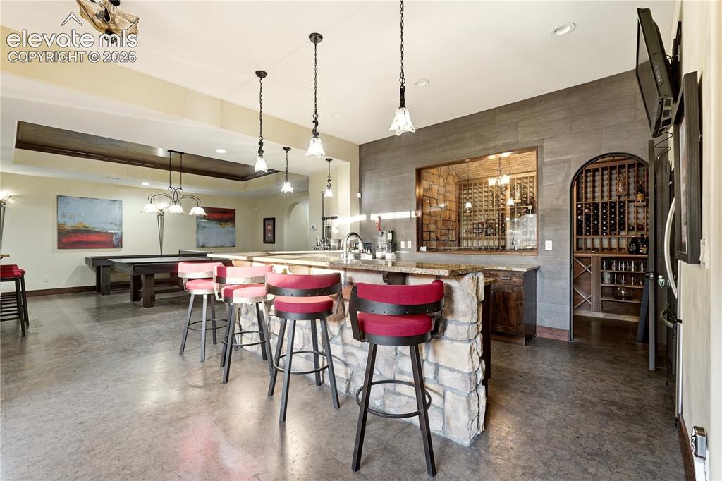 Image 32 of 46: Basement bar with wine cellar