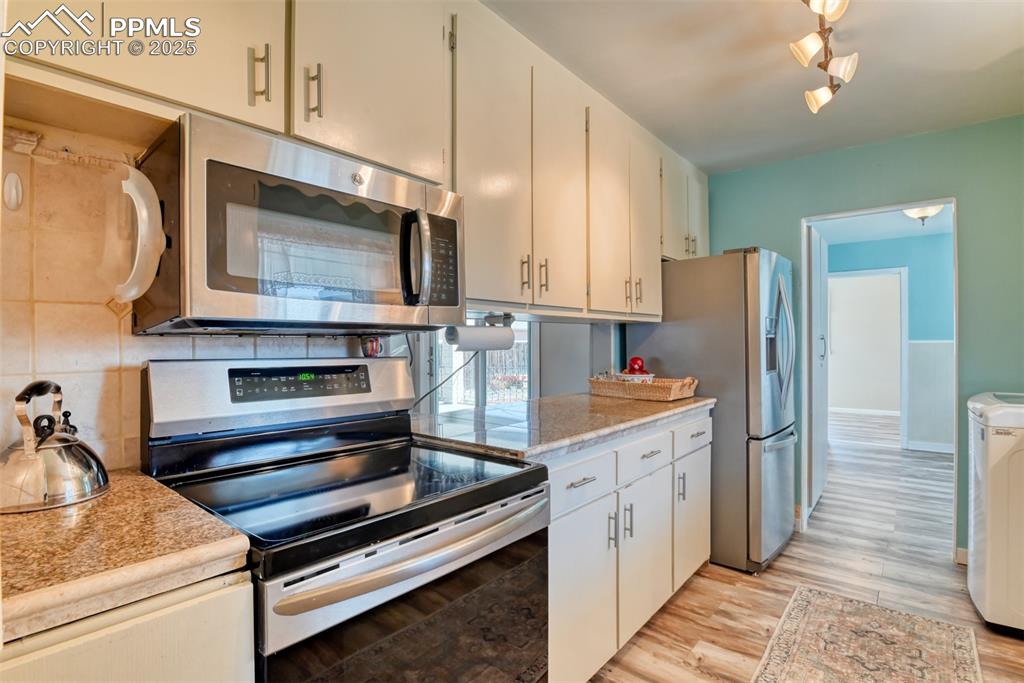 Image 3 of 47: Primary Kitchen featuring stainless steel appliances, tasteful backsplash,