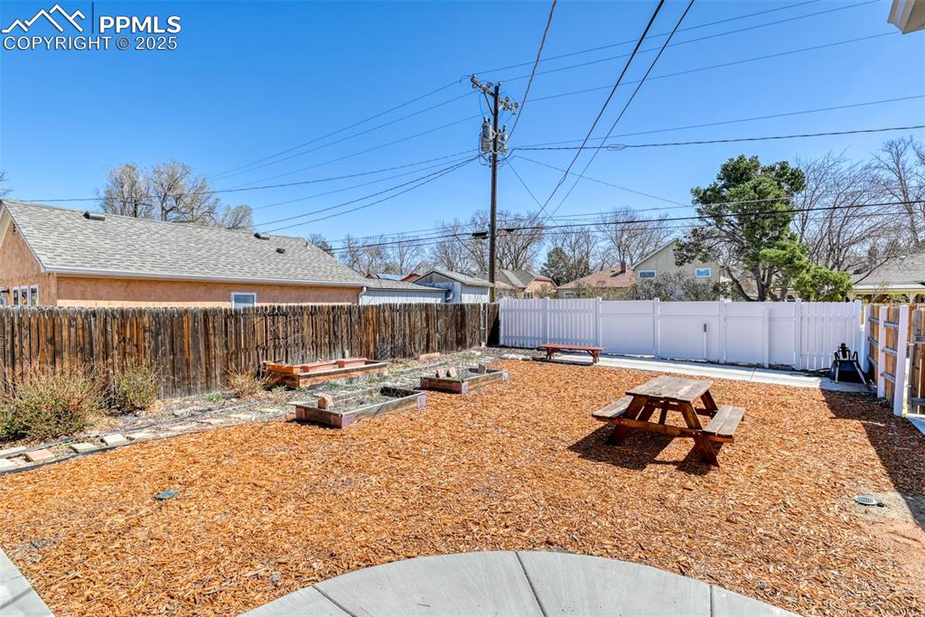 Image 37 of 47: View of yard with a fenced backyard and a vegetable garden