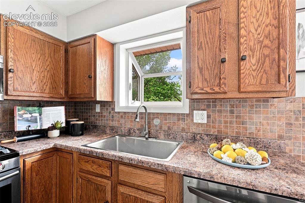 Image 14 of 33: Garden window above sink great for growing herbs or plants, view of large b