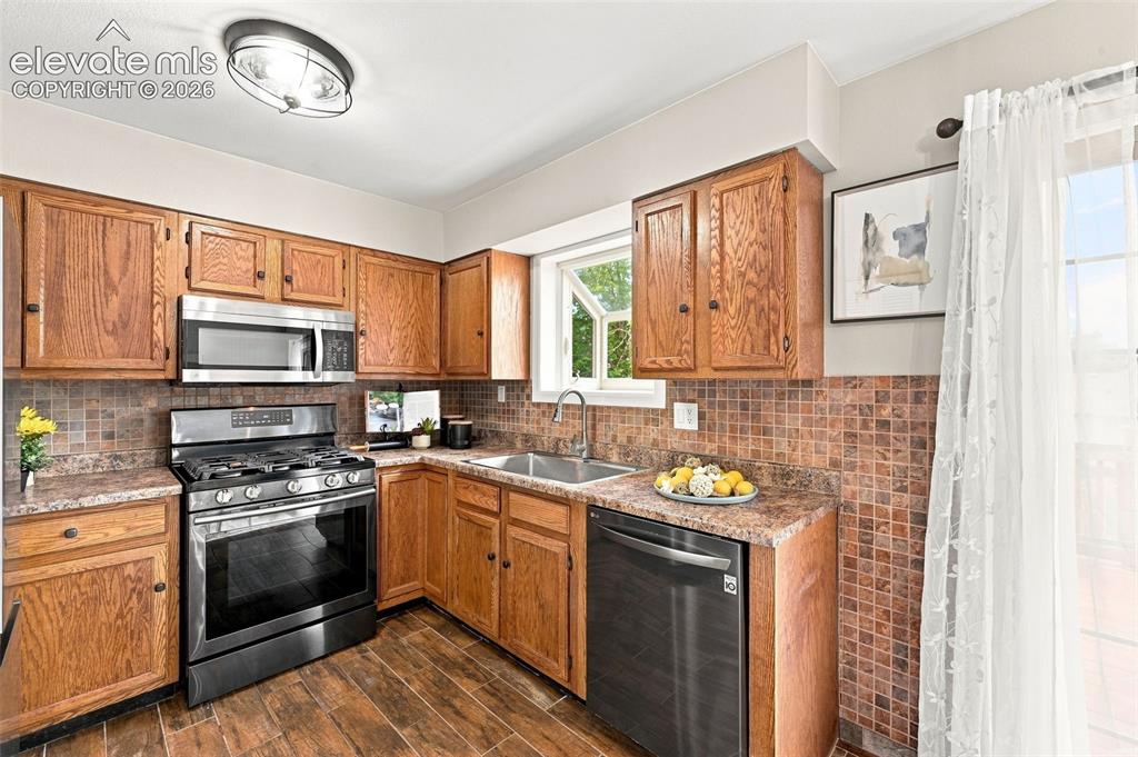 Image 3 of 33: All stainless steel appliances, gas range, large basin sink. Oak cabinets