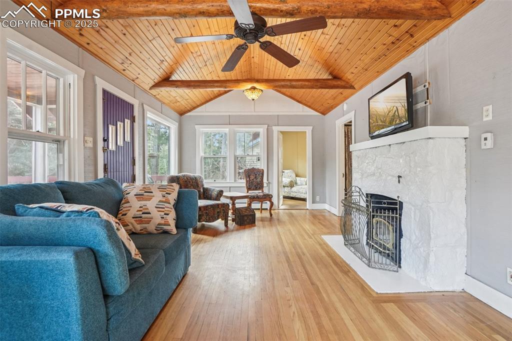 Image 10 of 43: Living room with wood flooring, wood ceilings accentuated by wood beams, a 