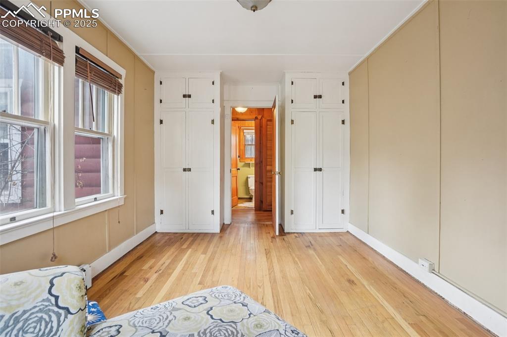 Image 19 of 43: Bedroom 2 off living room bringing you to the primary bedroom