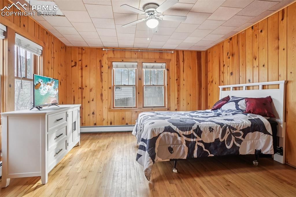 Image 21 of 43: Primary bedroom with walk out to private deck and yard