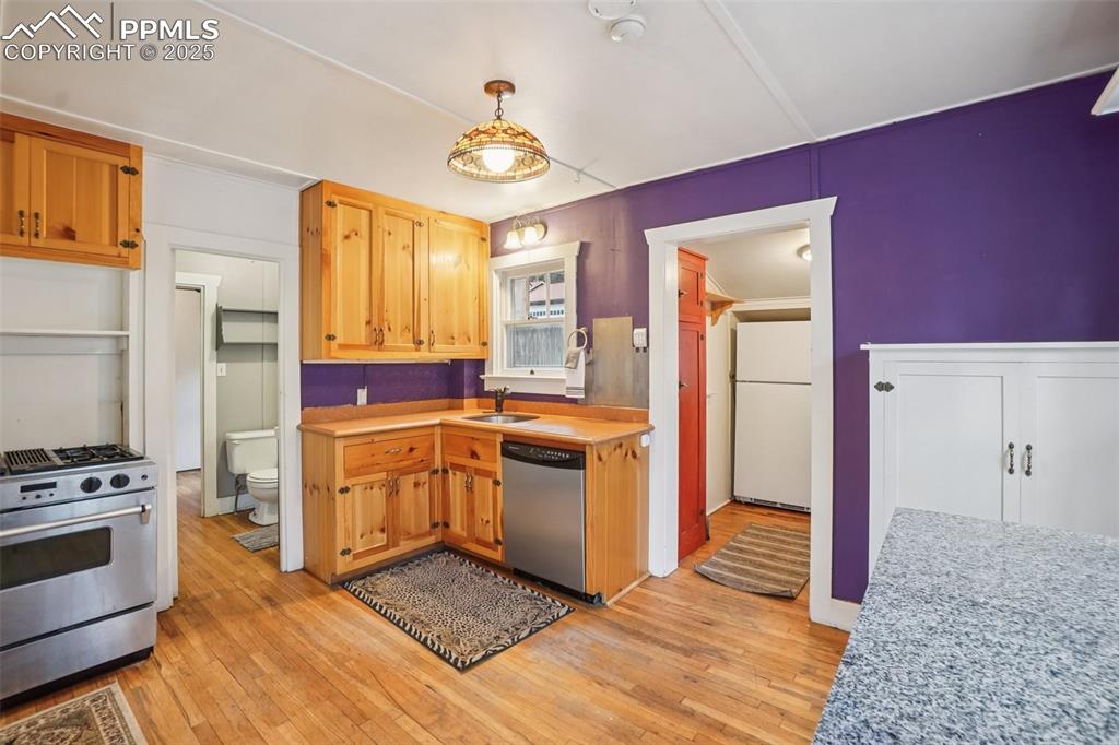 Image 4 of 43: Kitchen with gas stove, plenty of cabinet space, movable island and wood fl