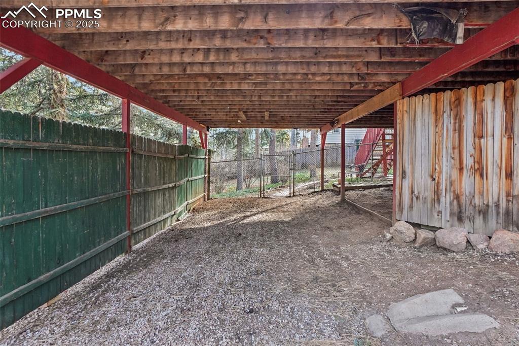 Image 40 of 43: Covered parking off lower level