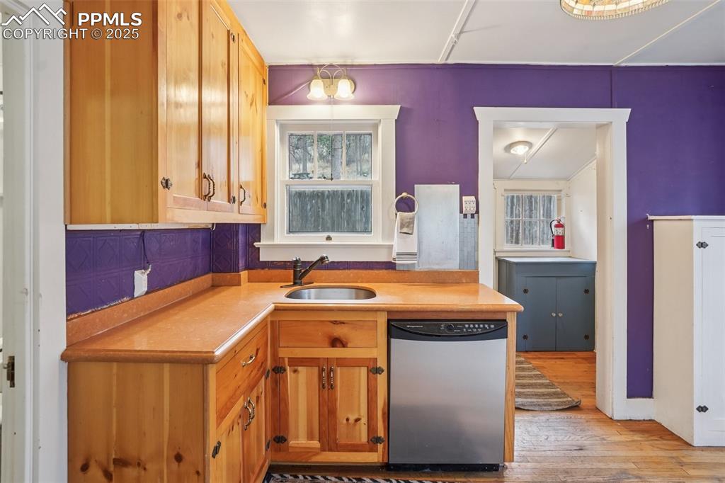 Image 5 of 43: Kitchen with gas stove, plenty of cabinet space, movable island and wood fl
