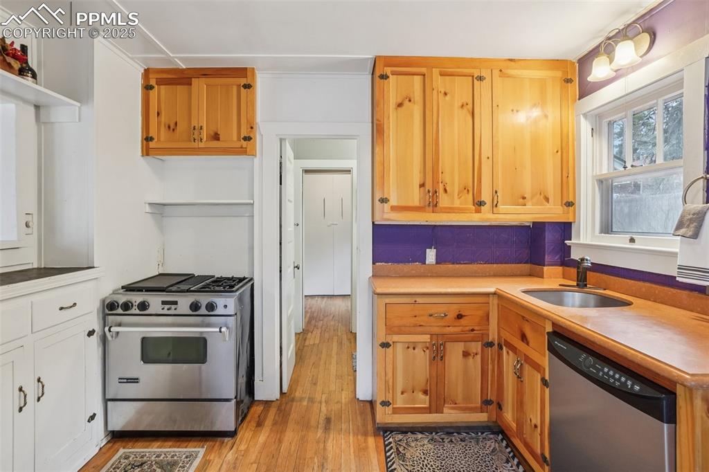 Image 6 of 43: Kitchen with gas stove, plenty of cabinet space, movable island and wood fl