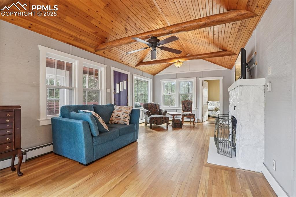 Image 9 of 43: Living room with wood flooring, wood ceilings accentuated by wood beams, a 
