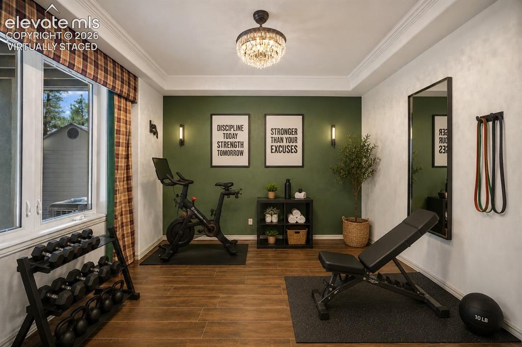 Image 29 of 42: Virtually Staged
Recessed ceiling with an ornate chandelier, wood-finish f
