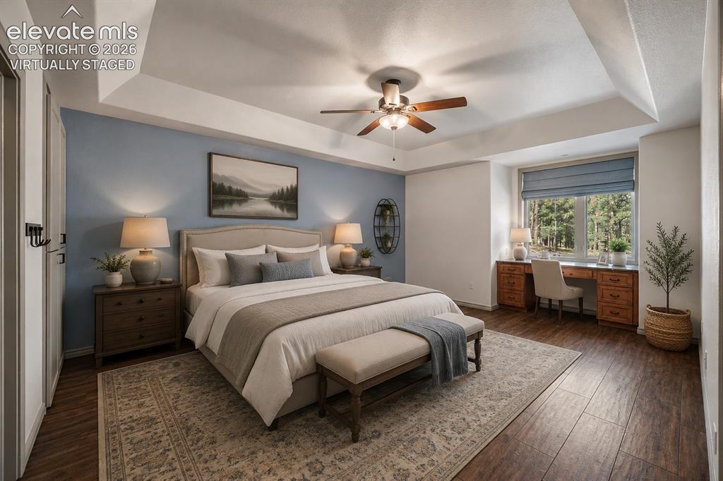 Image 33 of 42: Virtually Staged Tray ceiling featuring a ceiling fan