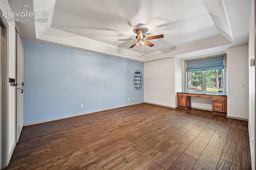 Image 34 of 42: Tray ceiling featuring a ceiling fan