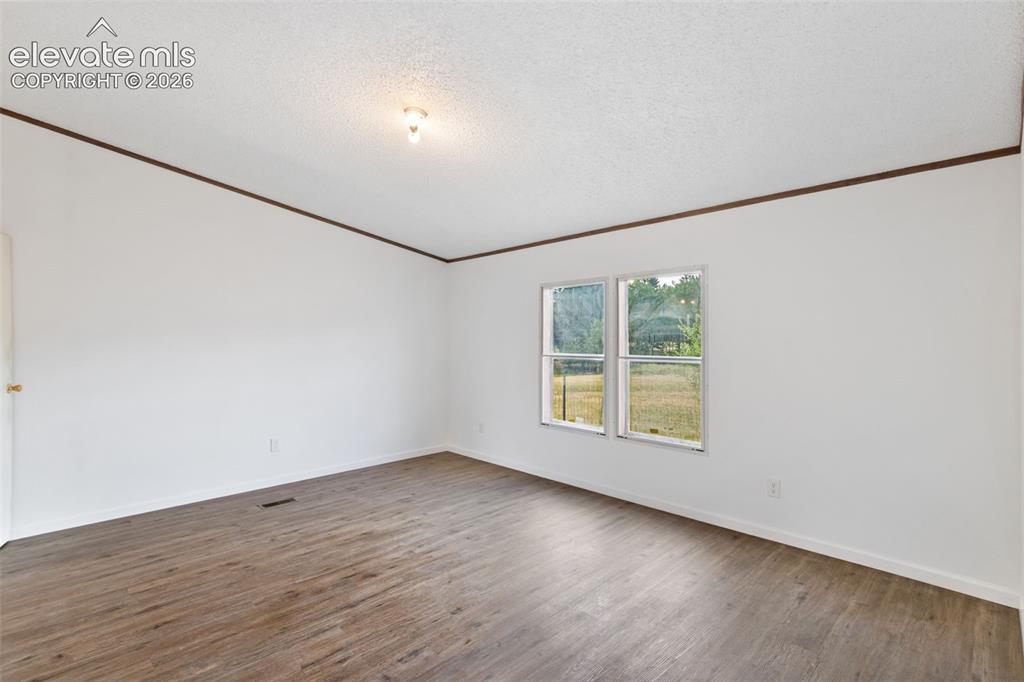 Image 7 of 24: Retreat to the primary suite featuring upgraded LVP flooring, a walk-in clo