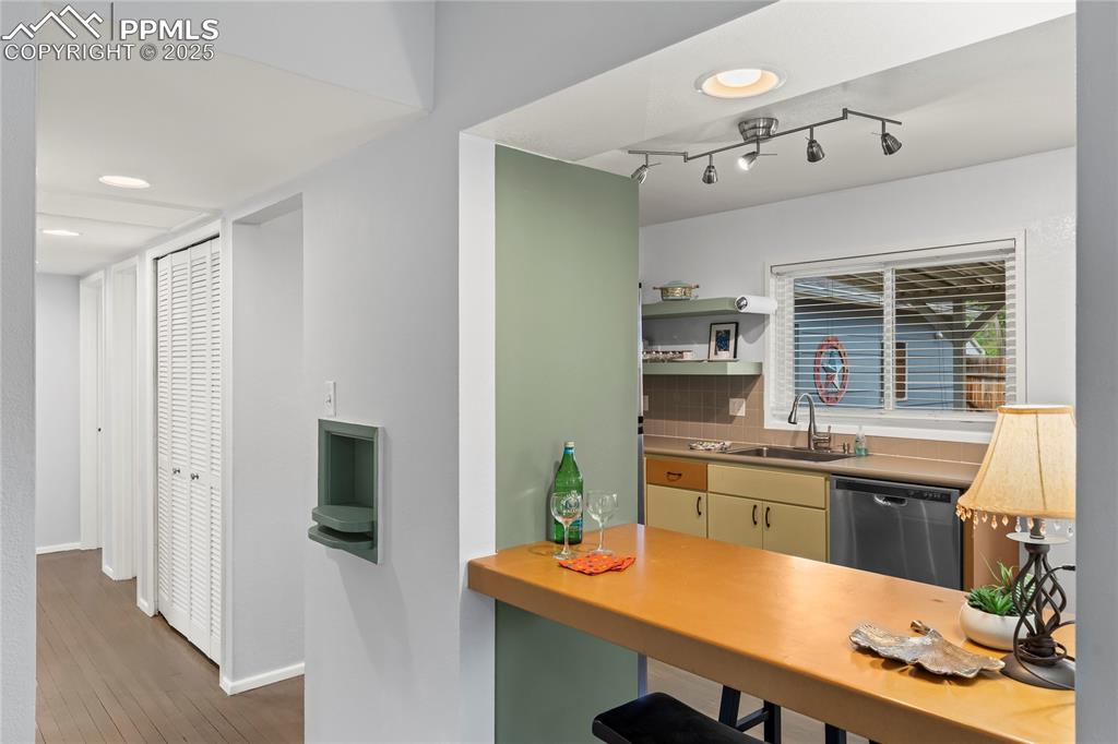 Image 8 of 30: Counter and backsplash (behind the island) are grey.