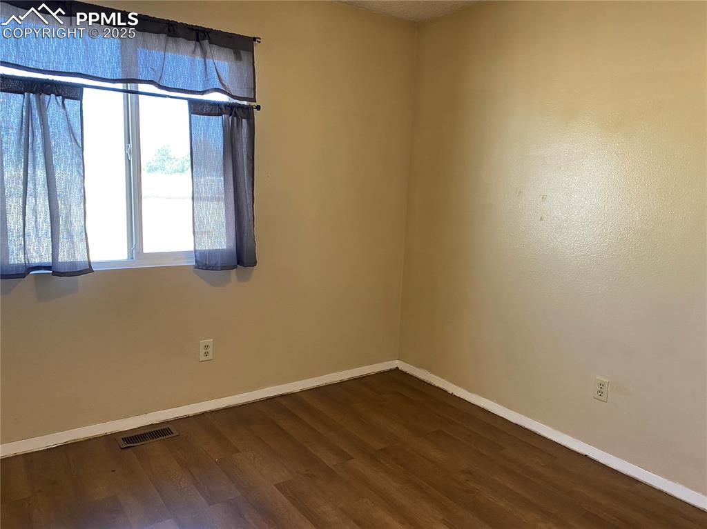 Image 14 of 15: Bedroom 2 dark wood-style flooring
