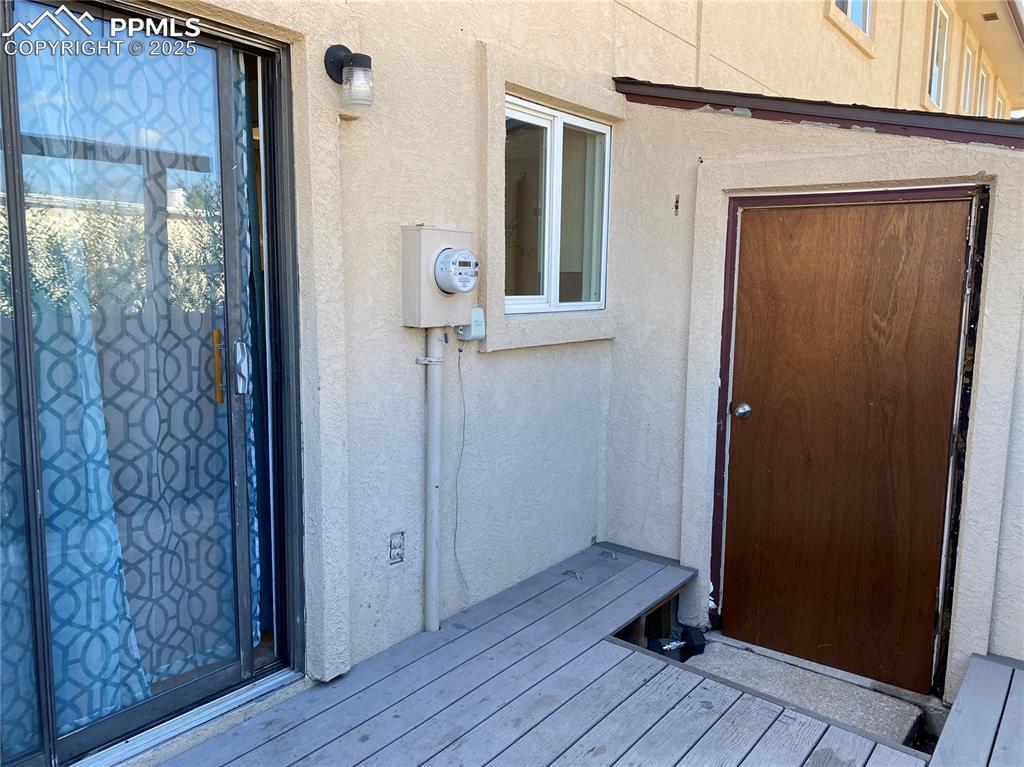 Image 8 of 15: Property entrance with stucco siding
