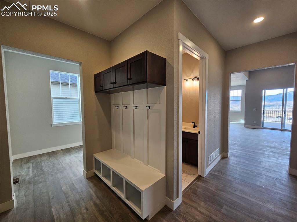 Image 18 of 20: Mudroom with dark wood finished floors