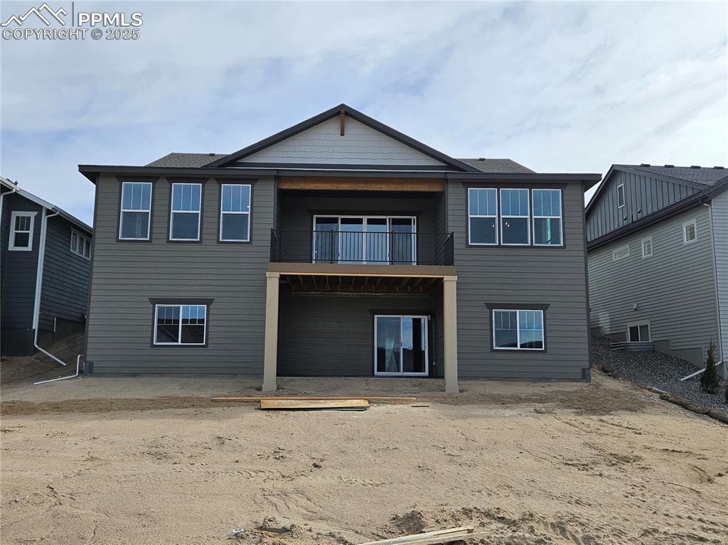 Image 2 of 20: Rear view of house with a patio and a balcony