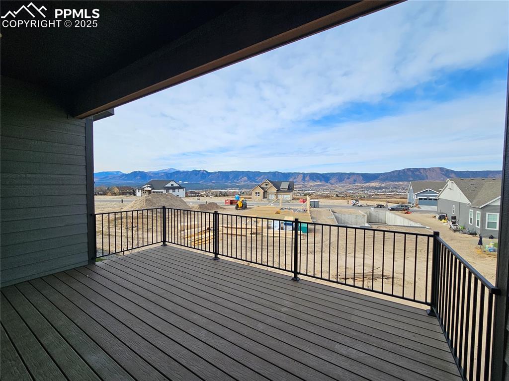 Image 6 of 20: Wooden terrace with a mountain view and a residential view