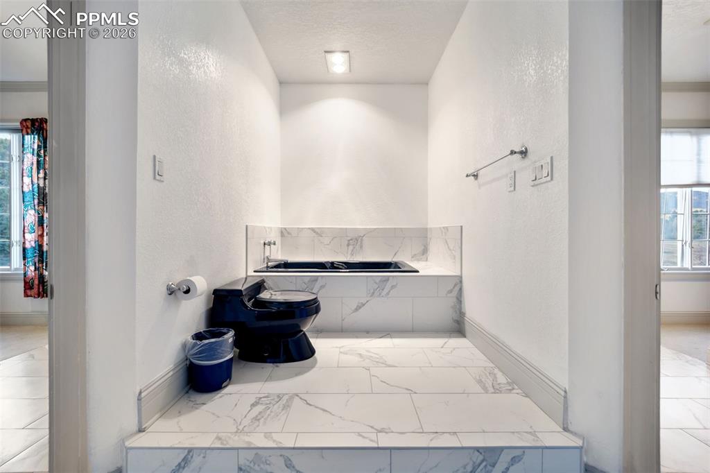 Image 21 of 50: Bathroom with large jetted tub