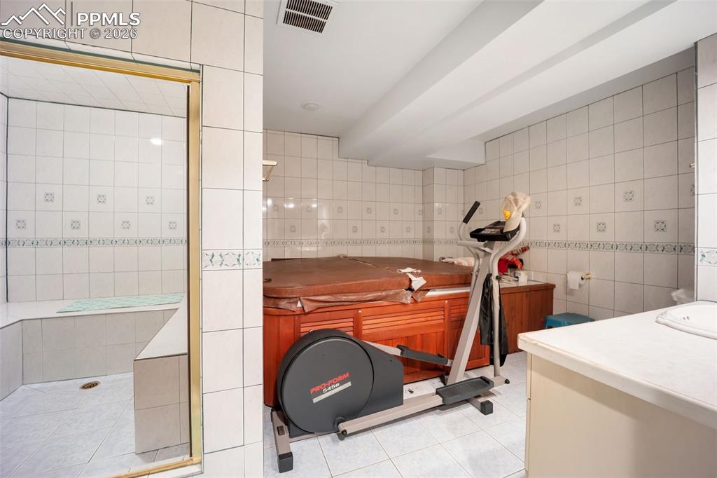 Image 37 of 50: Basement Sauna with Hot Tub and Steam Room