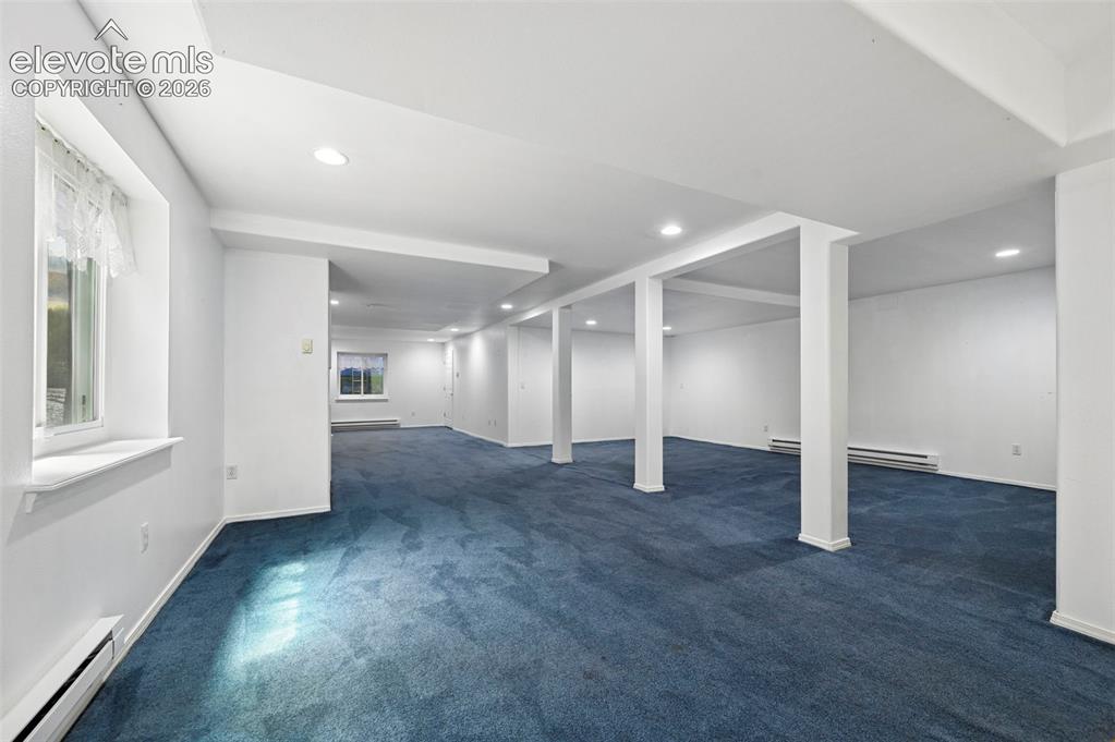 Image 28 of 38: Expansive room with recessed lighting, multiple windows, carpet flooring, a