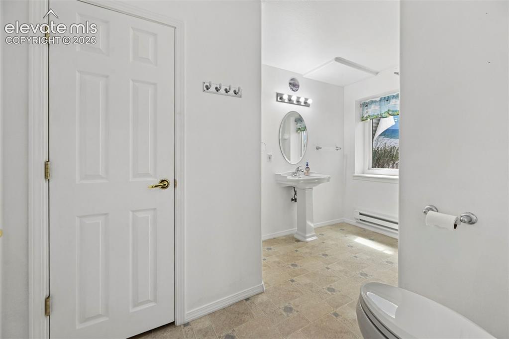 Image 31 of 38: White paneled door with brass hardware