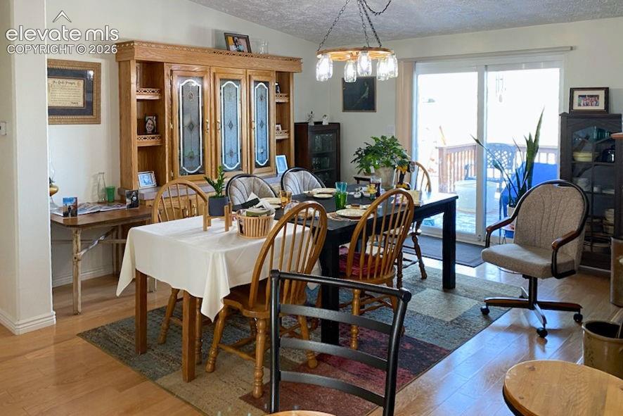 Image 8 of 15: Dining space featuring light wood-finish flooring, a built-in wood cabinet 