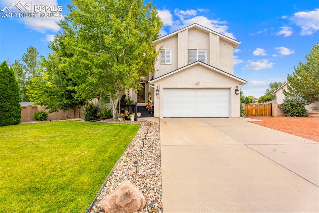 Image 1 of 32: Inviting front view of the home featuring a long, elongated driveway leadin