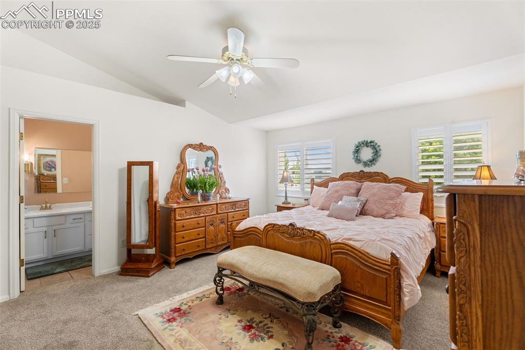 Image 13 of 32: Spacious primary bedroom with brand-new carpet, soaring ceilings, and windo