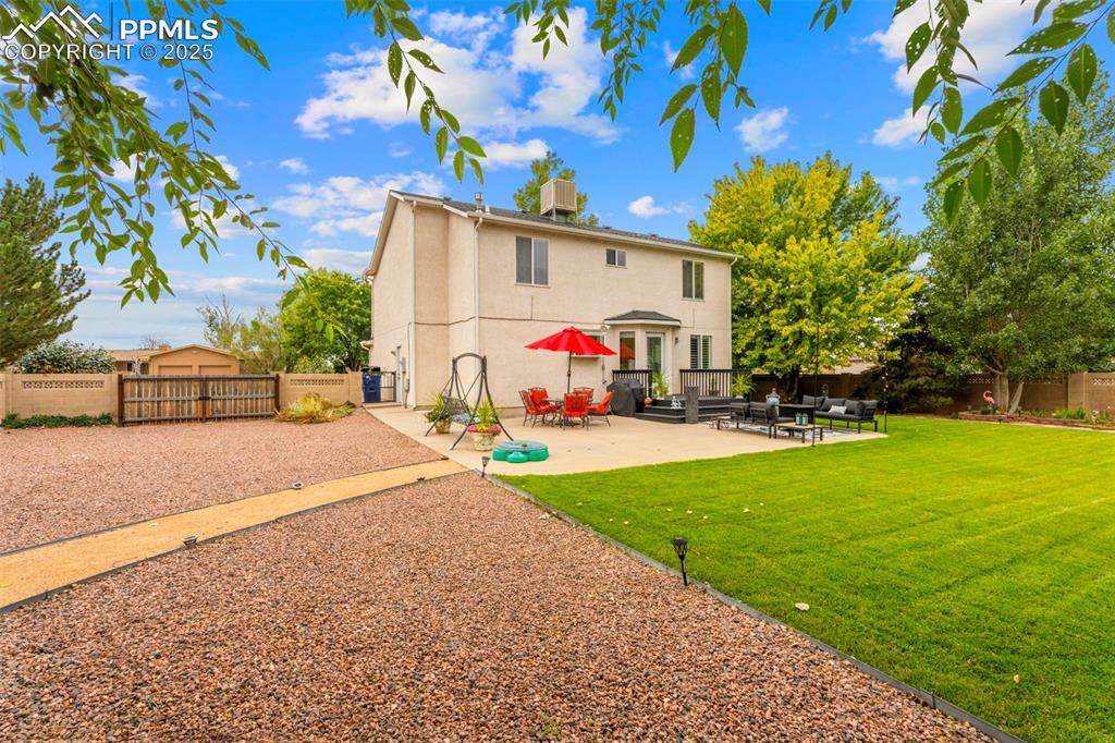 Image 25 of 32: Rear view of property featuring a patio area, a fenced backyard, and stucco