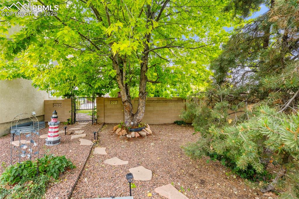 Image 26 of 32: View of yard with a gate