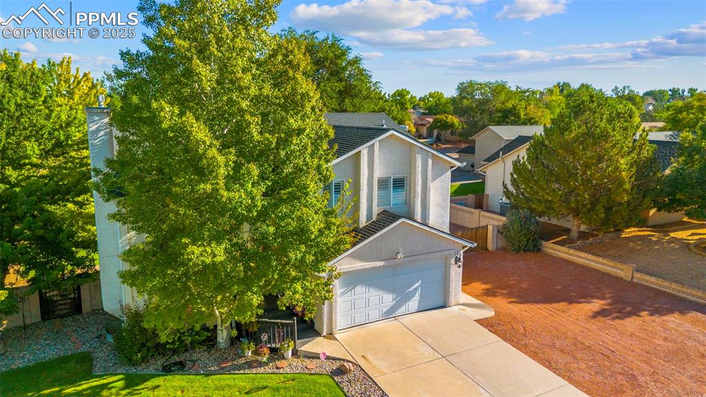 Image 28 of 32: View of front of property with stucco siding, concrete driveway, and a gara