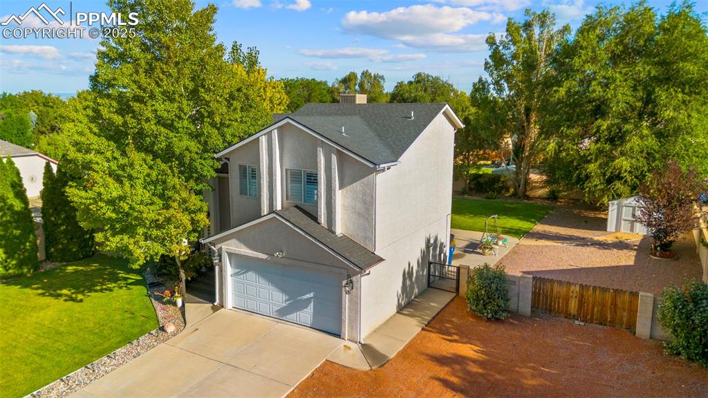 Image 29 of 32: View of front of home with a shingled roof, driveway, stucco siding, an att