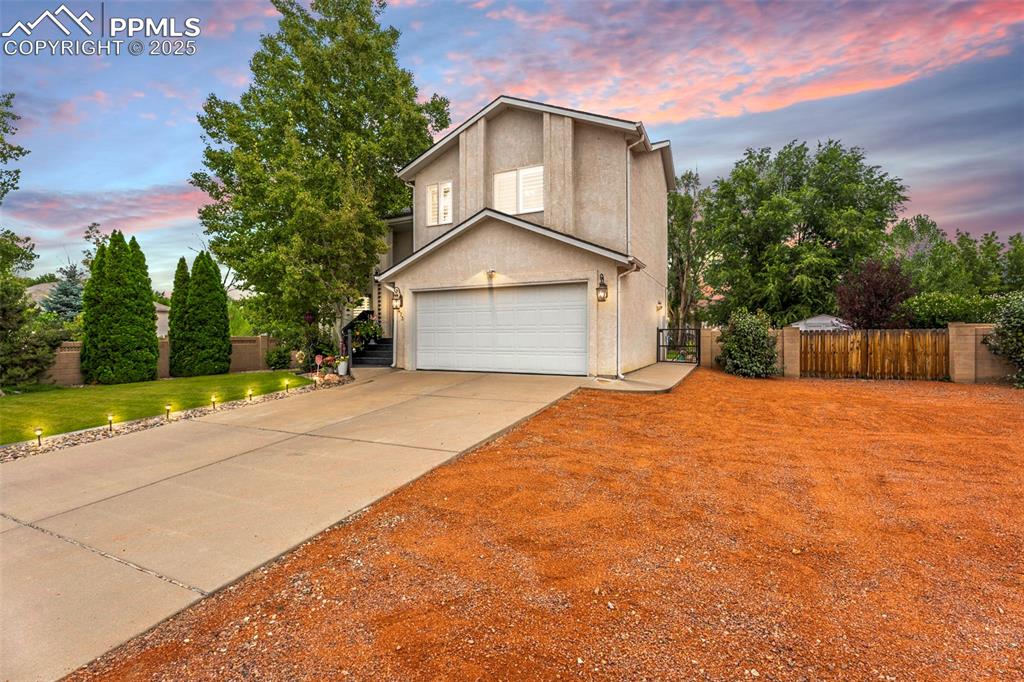 Image 32 of 32: Traditional-style home featuring concrete driveway, an attached garage, stu